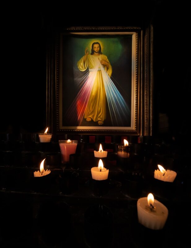 a lit candle in a dark room